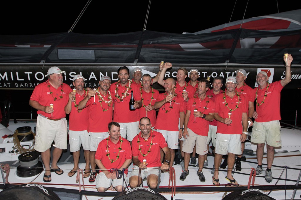 Mark Richards (with champagne bottle), and Roy P. Disney (on his right), celebrate with the crew aboard Wild Oats XI following the finish of the Transpac Race from Los Angeles to Honolulu. (Image credit: Sharon Green/Ultimate Sailing) 